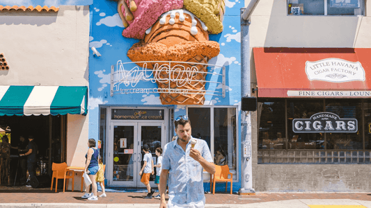 A man enjoying ice cream in Little Havana, Miami, stands in front of Azucar, showing the street life and culture that's central to local content marketing strategies in Miami.
